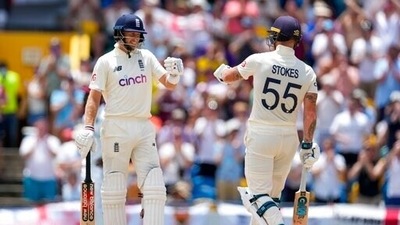 England's captain Joe Root and teammate Ben Stokes celebrate during day two of their second cricket Test match against West Indies at the Kensington Oval in Bridgetown. (AP)