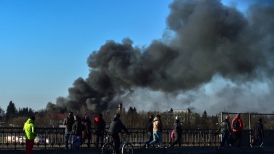 People walk as a cloud of smoke raises after an explosion near the airport, in Lviv, western Ukraine (AP) People walk as a cloud of smoke raises after an explosion near the airport, in Lviv, western Ukraine (AP)