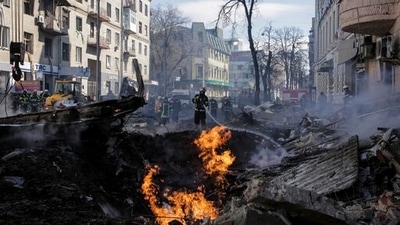 Firefighters extinguish a fire after a Russian rocket attack in Kharkiv (AP Photo/Pavel Dorogoy, File) (AP)