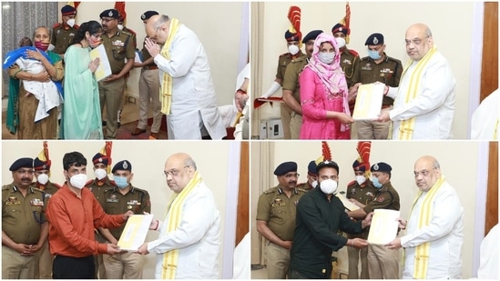 Union home minister Amit Shah hands over appointment letters to the kin of Jammu and Kashmir Police personnel who lost their lives fighting terrorists(Twitter/Amit Shah)