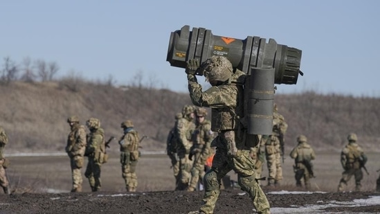 A Ukrainian serviceman carries an NLAW anti-tank weapon. (AP)