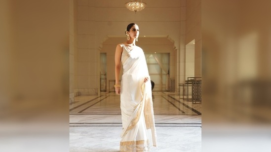 Vaani Kapoor kept her look simple yet very elegant by pairing it with a golden sleeveless blouse and gold chandbalis.(Instagram/@_vaanikapoor_)