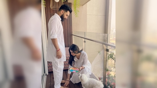 In another picture, Mouni Roy can be seen applying colour on her husband Suraj Nambiar's feet. Sharing the beautiful pictures, Mouni Roy wrote, "May your lives forever be filled with colours of joy, love & laughter."(Instagram/@imouniroy)