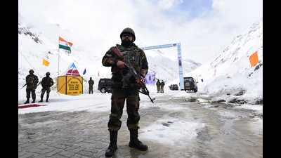 An army officer stands guard during the road opening ceremony of Zojila pass on the Srinagar-Kargil-Leh Road on Saturday. (Waseem Andrabi/HT)