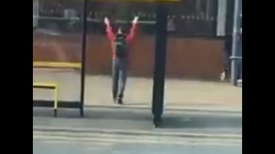 The image, taken from the Twitter video, shows the man dancing while waiting at a bus stop. (Twitter/@hayley louise taylor)