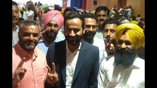 Two-time Barnala MLA Gurmeet Singh Meet Hayer with supporters at the ceremony at Raj Bhawan on Saturday.  (Sanjeev Sharma/HT)