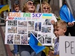 A Ukrainian woman hold a sign with news pictures showing the damage caused to Ukraine from Russia's invasion of the country during a rally in support of Ukraine in Los Angeles Saturday, March 19, 2022. (AP Photo/Damian Dovarganes)(AP) A Ukrainian woman hold a sign with news pictures showing the damage caused to Ukraine from Russia's invasion of the country during a rally in support of Ukraine in Los Angeles Saturday, March 19, 2022. (AP Photo/Damian Dovarganes)(AP)