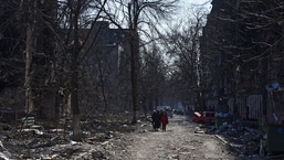 Local residents walk near residential buildings which were damaged during Ukraine-Russia conflict in the besieged southern port city of Mariupol, Ukraine March 18, 2022. REUTERS/Stringer