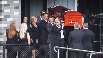The coffin of Shane Warne is carried to a hearse at the St Kilda Football Club (REUTERS)