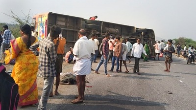 People gather near the mangled remains of a passenger bus after an accident, near Tumakuru, Saturday, March 19, 2022. (PTI Photo) (PTI) People gather near the mangled remains of a passenger bus after an accident, near Tumakuru, Saturday, March 19, 2022. (PTI Photo) (PTI)