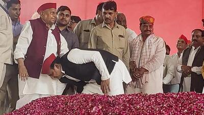 Samajwadi Party national president Akhilesh Yadav seeks blessings from his father and party chief patron Mulayam Singh Yadav at a Holi gathering in Saifai, Etawah. (PTI Photo) Samajwadi Party national president Akhilesh Yadav seeks blessings from his father and party chief patron Mulayam Singh Yadav at a Holi gathering in Saifai, Etawah. (PTI Photo)