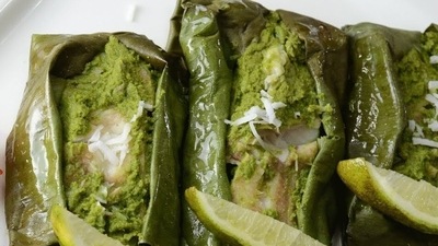 Patra Ni Machi: In this recipe, the fish is quoted with rich green chutney made of fresh mint and coriander leaves, garlic, coconut, green chilli, cumin seeds, lemon juice, wrapped in banana leaf, and steamed. (YouTube) Patra Ni Machi: In this recipe, the fish is quoted with rich green chutney made of fresh mint and coriander leaves, garlic, coconut, green chilli, cumin seeds, lemon juice, wrapped in banana leaf, and steamed. (YouTube)