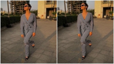 Rubina paired a full-sleeved monochrome silk top with a pair of silk trousers of the same print with wide legs. Rubina’s midriff-baring top came with knot-details near to the waist. (Instagram/@rubinadilaik)