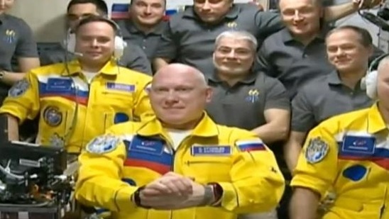 A screenshot from video provided by Roscosmos showing Russian cosmonauts wearing blue and yellow outfits. The photos were widely shared on social media.(BBC)