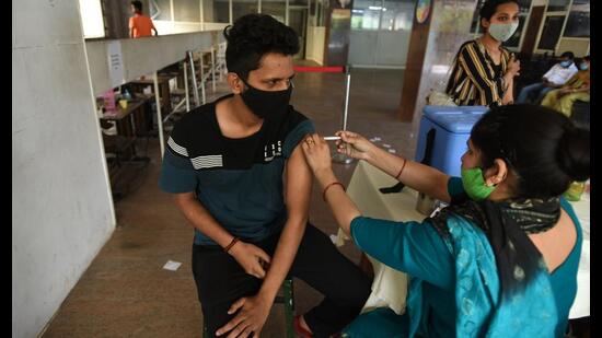 A person gets a dose of Covid-19 vaccine at the district hospital in Noida’s Sector 30 on Sunday. (Sunil Ghosh /HT)