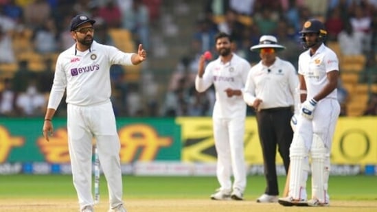 India's captain Rohit Sharma, left, gestures to his fielders&nbsp;(AP)