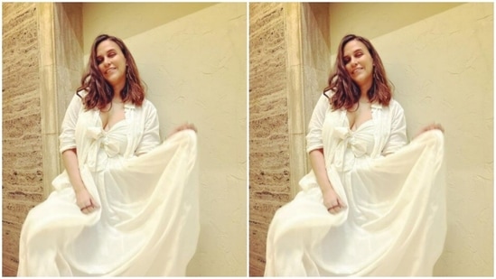 Neha’s midriff-baring white gown came with knot details and a collared quarter-sleeved shrug.(Instagram/@nehadhupia)