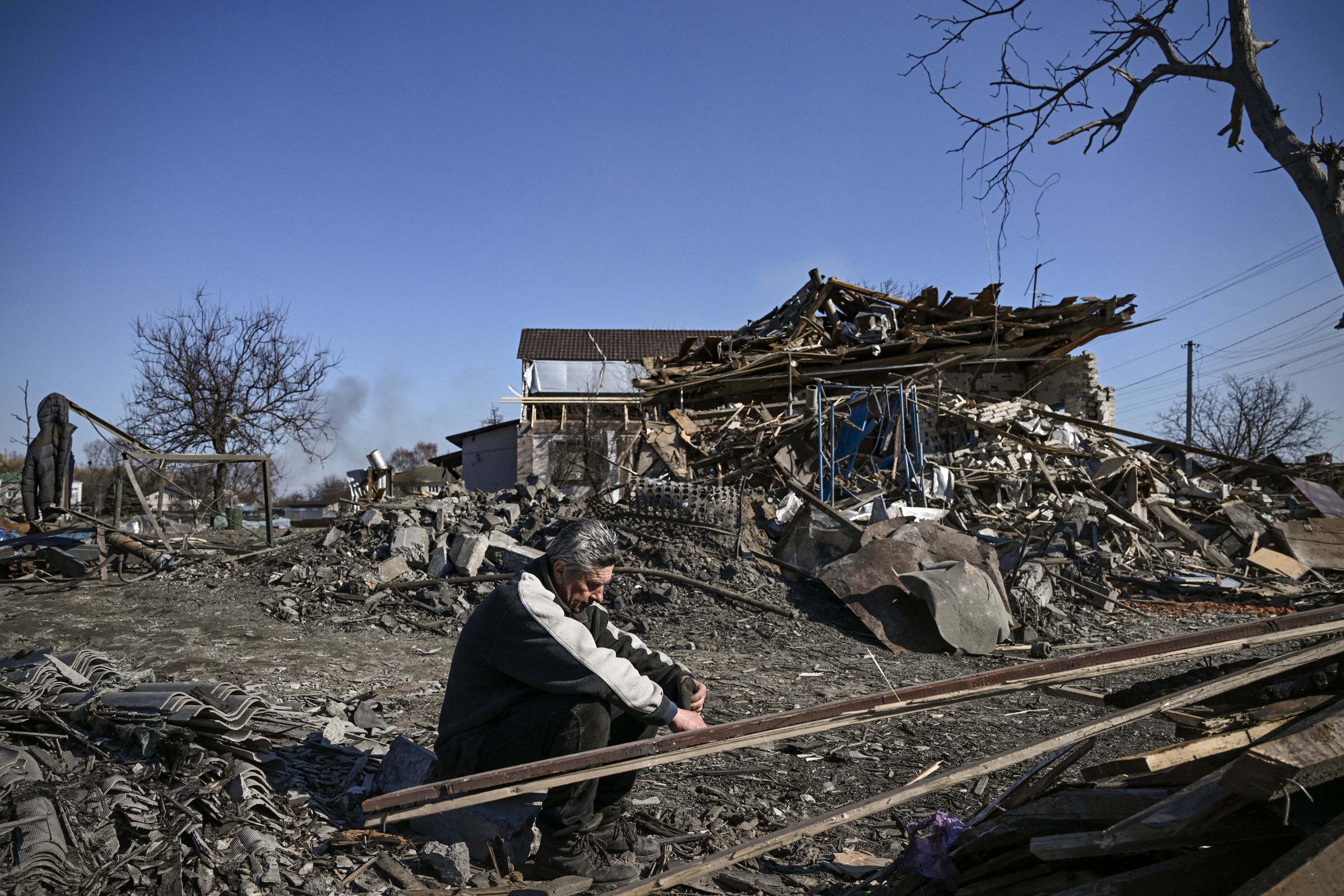 A man sits in front of a destroyed house after bombardments in the village of Krasylivka, east of Kyiv, Ukraine, on Sunday. (AFP) A man sits in front of a destroyed house after bombardments in the village of Krasylivka, east of Kyiv, Ukraine, on Sunday. (AFP)
