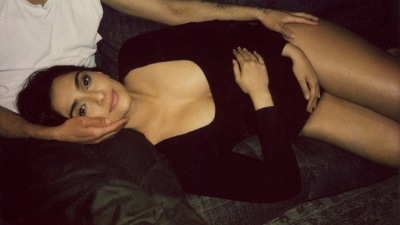 In the stills, mommy-to-be Sonam Kapoor can be seen lying on her husband Anand Ahuja's lap as she puts her hands on her baby bump. (Instagram/@sonamkapoor) In the stills, mommy-to-be Sonam Kapoor can be seen lying on her husband Anand Ahuja's lap as she puts her hands on her baby bump. (Instagram/@sonamkapoor)