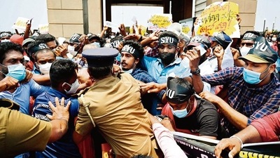 Police try to stop demonstrators during a protest against the rising living costs, outside the president's office in Colombo on Friday.&nbsp; (AFP)