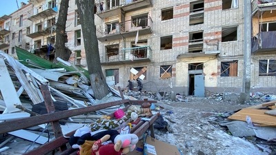 Municipal workers and volunteers remove debris of a damaged residential building in Kharkiv. (REUTERS)