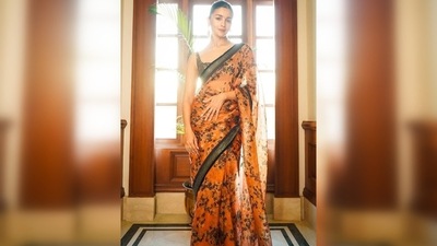Alia Bhatt teamed her drape with a shimmery bronze sleeveless blouse and earrings from Sabyasachi's jewellery line. (Instagram/@sabyasachiofficial) Alia Bhatt teamed her drape with a shimmery bronze sleeveless blouse and earrings from Sabyasachi's jewellery line. (Instagram/@sabyasachiofficial)