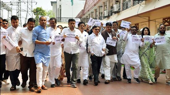 Guwahati: Opposition MLAs holding posters, raise slogans after staging a walkout from the ongoing Assam assembly budget session, accusing the Bharatiya Janata Party (BJP) of horse-trading for Rajya Sabha elections. (ANI)