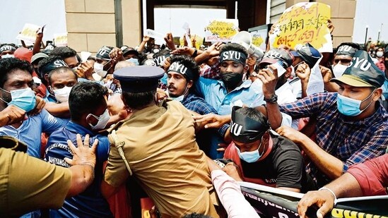 Police attempt to arrest protesters during a demonstration against the rising cost of living outside the president's office in Colombo on Friday.  (AFP)