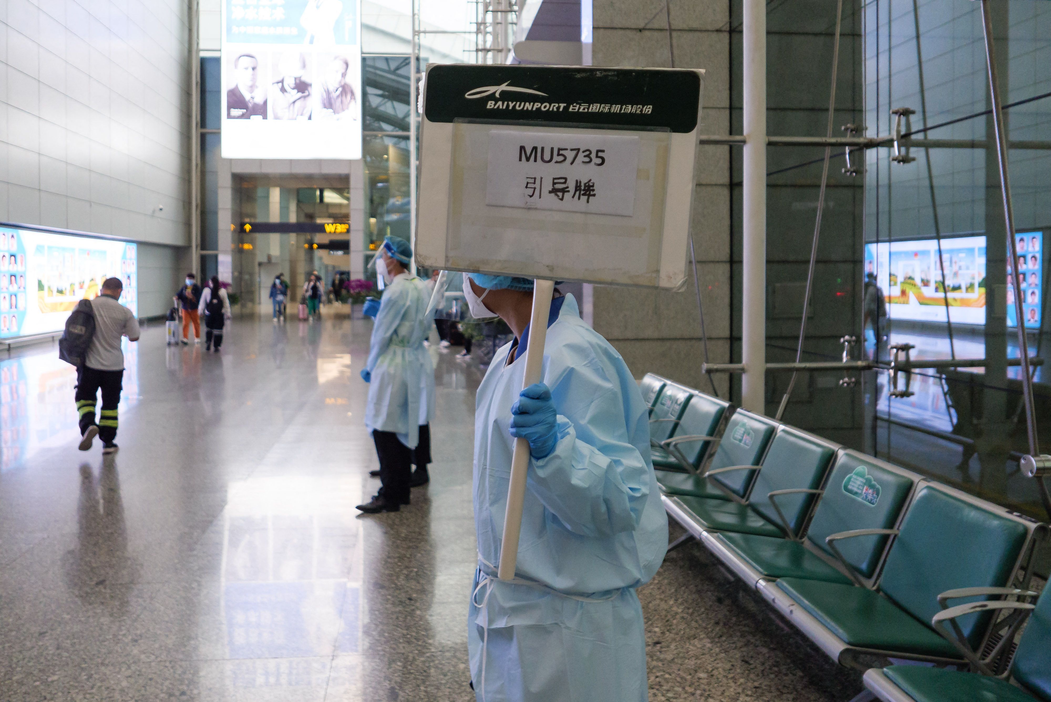 A staff member holds up a board to guide relatives of passengers on China Eastern flight MU5375 after it failed to arrive at Guangzhou Baiyun International Airport in China's southern Guangdong province on March 21, 2022. (AFP) A staff member holds up a board to guide relatives of passengers on China Eastern flight MU5375 after it failed to arrive at Guangzhou Baiyun International Airport in China's southern Guangdong province on March 21, 2022. (AFP)
