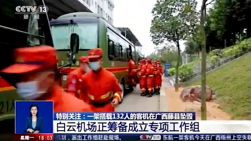 In this image taken from video footage run by China's CCTV, emergency personnel prepare to travel to the site of a plane crash near Wuzhou. (AP) In this image taken from video footage run by China's CCTV, emergency personnel prepare to travel to the site of a plane crash near Wuzhou. (AP)