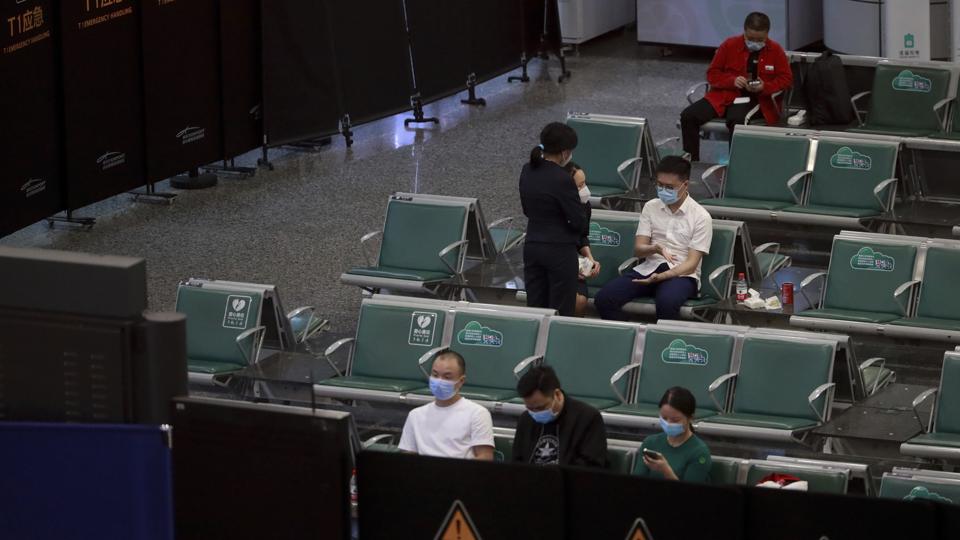 People sit in a temporarily cordoned off area for the relatives of the victims aboard China Eastern’s flight MU5735, in Guangzhou Baiyun International Airport.&nbsp; (AP)
