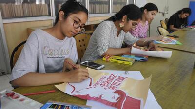 Students preparing posters to mark the martyrdom day of Shaheed Bhagat Singh at GGDSD College, Sector 32, in Chandigarh on Tuesday. (Keshav Singh/HT)