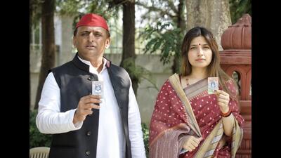 Samajwadi Party president Akhilesh Yadav and his wife and former MP Dimple Yadav show their voter ID card upon arrival to cast their vote at a polling booth in Saifai on February 20 . (HT File Photo)