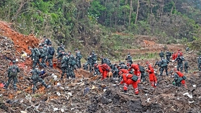 Rescue workers search for the black boxes at a plane crash site in Tengxian county, southwestern China's Guangxi Zhuang Autonomous Region. (AP) Rescue workers search for the black boxes at a plane crash site in Tengxian county, southwestern China's Guangxi Zhuang Autonomous Region. (AP)