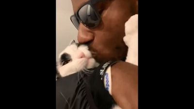 The image, taken from the Reddit video, shows the man holding the cat while showering it with kisses. (Reddit/@H_G_Bells)
