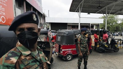 Sri Lanka's Army members stand guard at a Ceylon Petroleum Corporation fuel station to help stations distribute oil during the fuel crisis, in Colombo, Sri Lanka . (REUTERS)