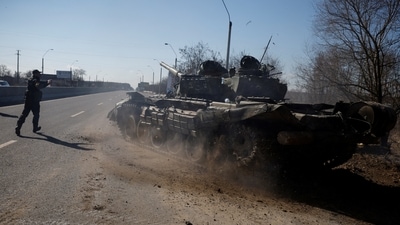 A Ukrainian soldier directs a Russian tank that Ukrainians captured after fighting with Russian troops, as Russia's attack on Ukraine continues, outside Brovary, near Kyiv, Ukraine. (REUTERS)