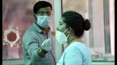 A health worker collects swab samples for Covid-19 test at the district hospital in Noida’s Sector 30 on Saturday. (Sunil Ghosh /HT) A health worker collects swab samples for Covid-19 test at the district hospital in Noida’s Sector 30 on Saturday. (Sunil Ghosh /HT)