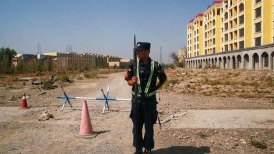 A Chinese police officer takes his position by the road near what is officially called a vocational education centre in Yining in Xinjiang Uighur Autonomous Region, China, in 2018. (REUTERS/FILE) A Chinese police officer takes his position by the road near what is officially called a vocational education centre in Yining in Xinjiang Uighur Autonomous Region, China, in 2018. (REUTERS/FILE)