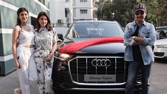 Shanaya Kapoor, her parents Maheep Kapoor and Sanjay Kapoor pose with her new car.