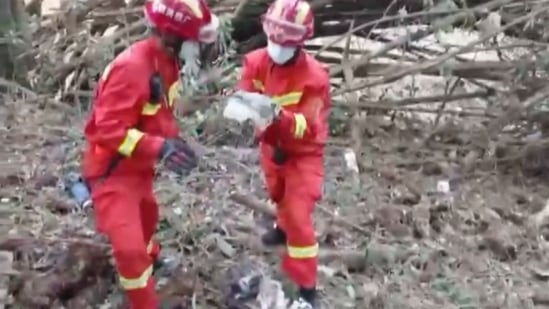 In this screengrab taken on March 21 from a video by state broadcaster China Central Television (CCTV) via AFPTV shows rescue teams searching the site of where a China Eastern passenger jet crashed onto a mountainside in Tengxian county in Wuzhou City in China's southern Guangxi region. (AFP)