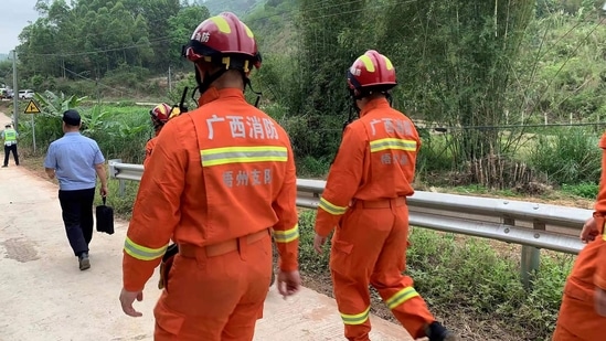 A base of operations was set up near the crash site with rescue vehicles, ambulances and an emergency power supply truck parked in the narrow space.(AFP)