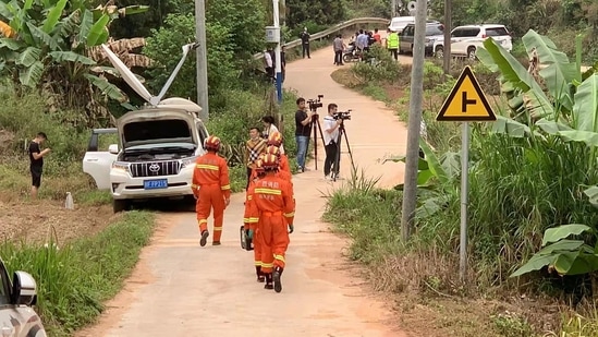 Soldiers in camouflage joined helmeted rescue workers in orange jumpsuits in combing the charred crash site and surrounding heavily dense vegetation.(AFP)