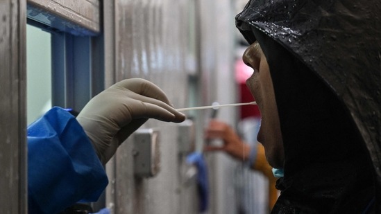 A man is tested as a measure against the Covid-19 coronavirus near the Shanghai Jin'an Central Hospital in Shanghai.(AFP) A man is tested as a measure against the Covid-19 coronavirus near the Shanghai Jin'an Central Hospital in Shanghai.(AFP)