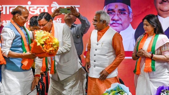 Union Defence Minister Rajnath Singh with Uttarakhand CM-designate Pushkar Singh Dhami, in Dehradun.(PTI)