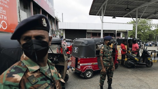 Sri Lanka's Army members stand guard at a Ceylon Petroleum Corporation fuel station to help stations distribute oil during the fuel crisis, in Colombo, Sri Lanka .(REUTERS)