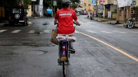 FILE PHOTO: A delivery worker of Zomato, an Indian food-delivery startup, rides her bicycle along a road in Kolkata, India, July 13, 2021. REUTERS/Rupak De Chowduri/File Photo(REUTERS)