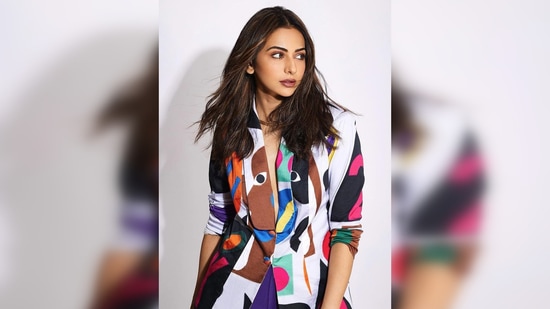 Rakul Preet paired her a vibrant multi-coloured blazer with bootcut blue pants and yellow pumps.(Instagram/@rakulpreet)