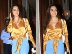 Actor Kiara Advani looks gorgeous in golden-coloured satin shirt.
