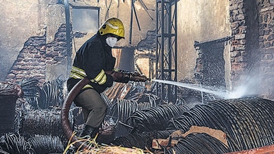 A firefighter douses flames at the godown in Bhoiguda area of Secunderabad on Wednesday (PTI) A firefighter douses flames at the godown in Bhoiguda area of Secunderabad on Wednesday (PTI)